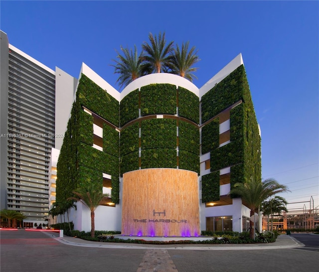 view of outdoor building at dusk