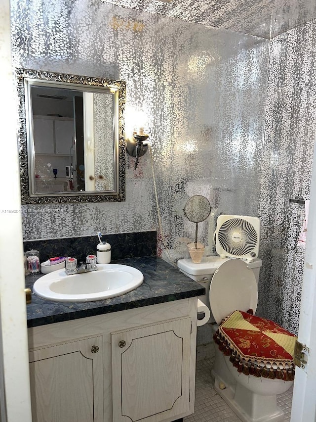 2025 NE 164th St Unit 215, North Miami Beach, FL 33162 - bathroom featuring toilet, vanity, and tile patterned floors