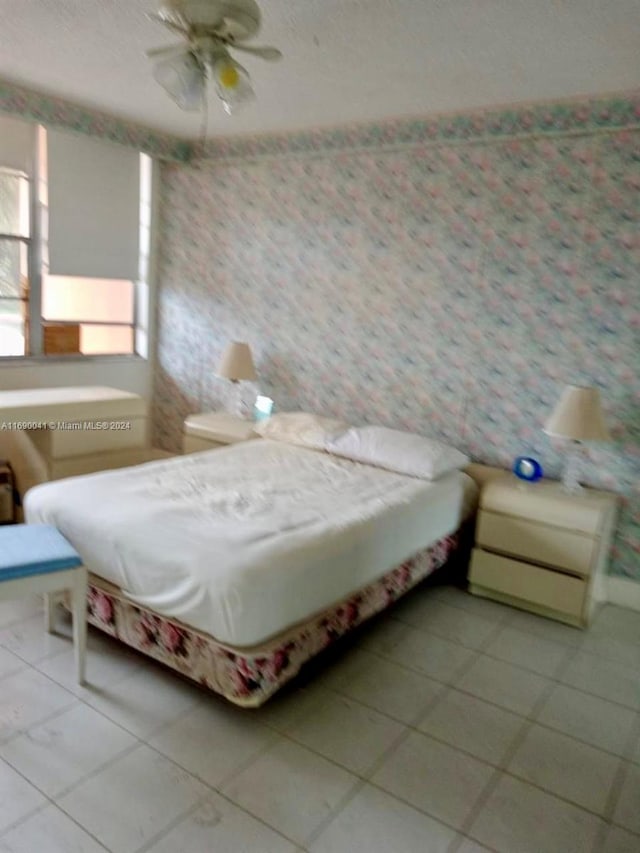 bedroom with tile patterned flooring and ceiling fan