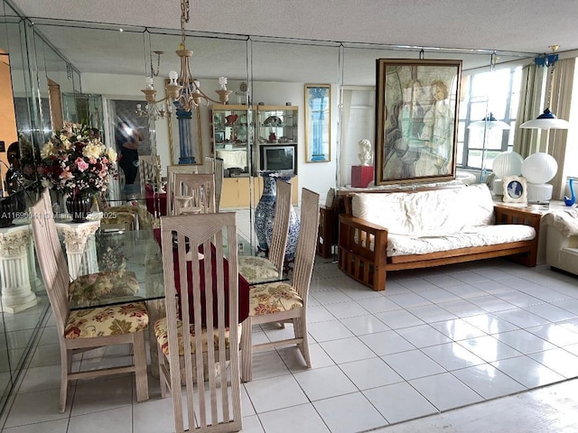 2025 NE 164th St Unit 215, North Miami Beach, FL 33162 - tiled dining space featuring a textured ceiling and a chandelier