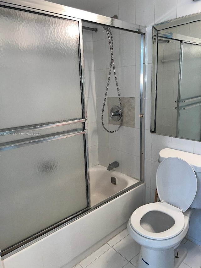 2025 NE 164th St Unit 215, North Miami Beach, FL 33162 - bathroom featuring enclosed tub / shower combo, toilet, and tile patterned floors