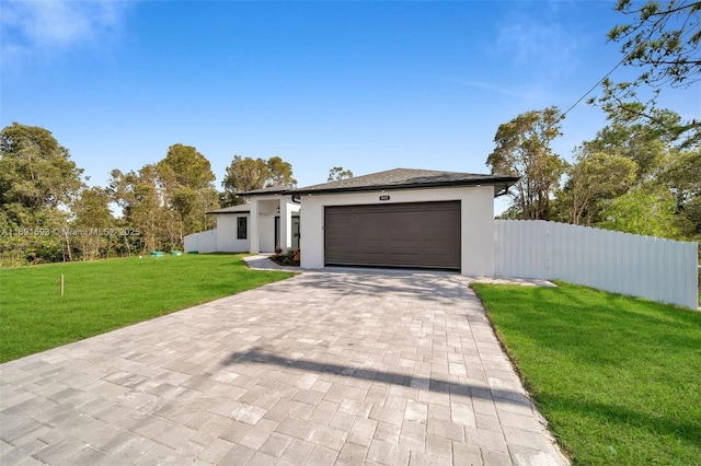 view of front of house with a garage and a front yard