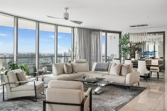 living room featuring tile patterned floors, plenty of natural light, ceiling fan, and a wall of windows