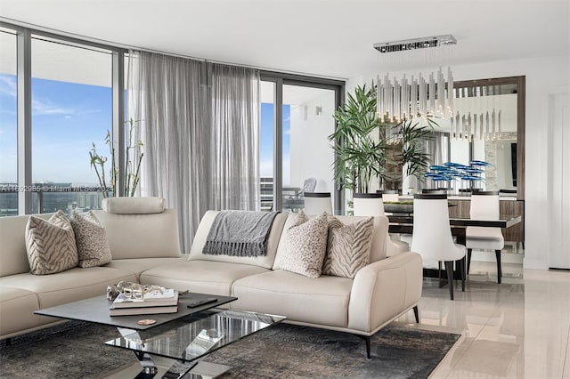 living room featuring a wall of windows, a water view, and plenty of natural light