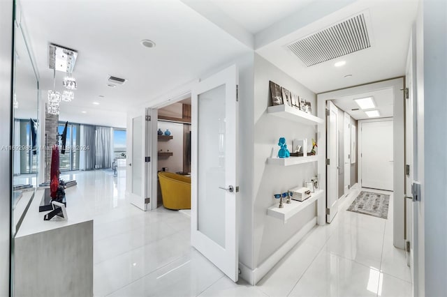 hall with light tile patterned floors