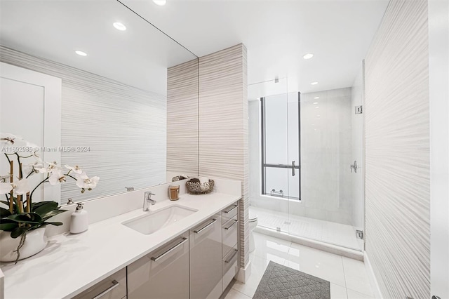 bathroom with tile patterned flooring, vanity, toilet, and a shower with shower door