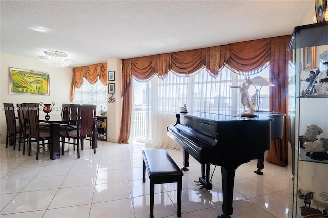 miscellaneous room with a textured ceiling and light tile patterned floors