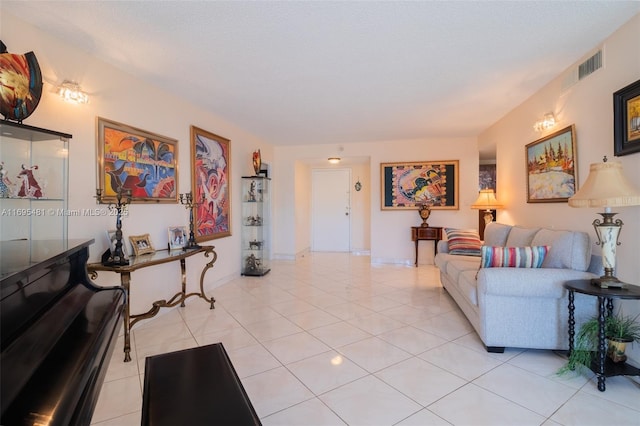 living room featuring light tile patterned floors and a textured ceiling