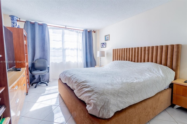 tiled bedroom with a textured ceiling