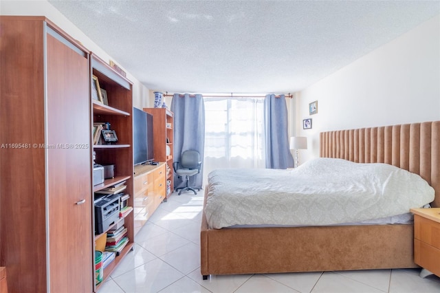 tiled bedroom featuring a textured ceiling