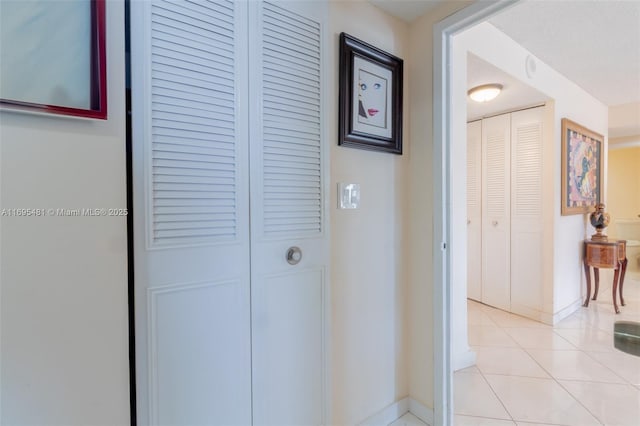 hall featuring light tile patterned flooring