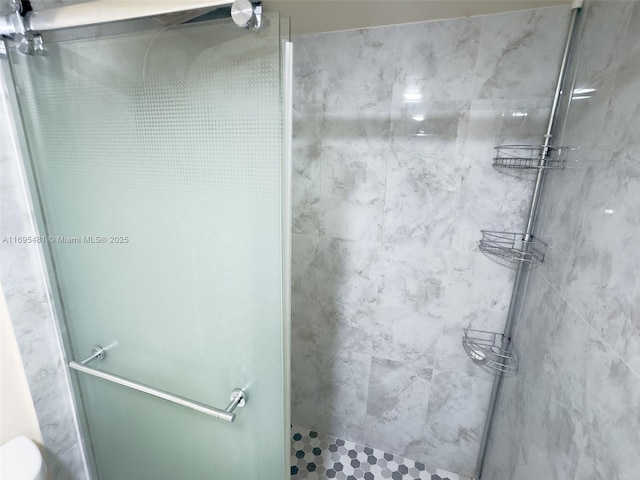 bathroom with a shower with door