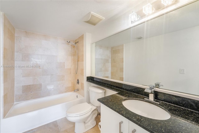 full bathroom featuring tile patterned flooring, vanity, toilet, and tiled shower / bath