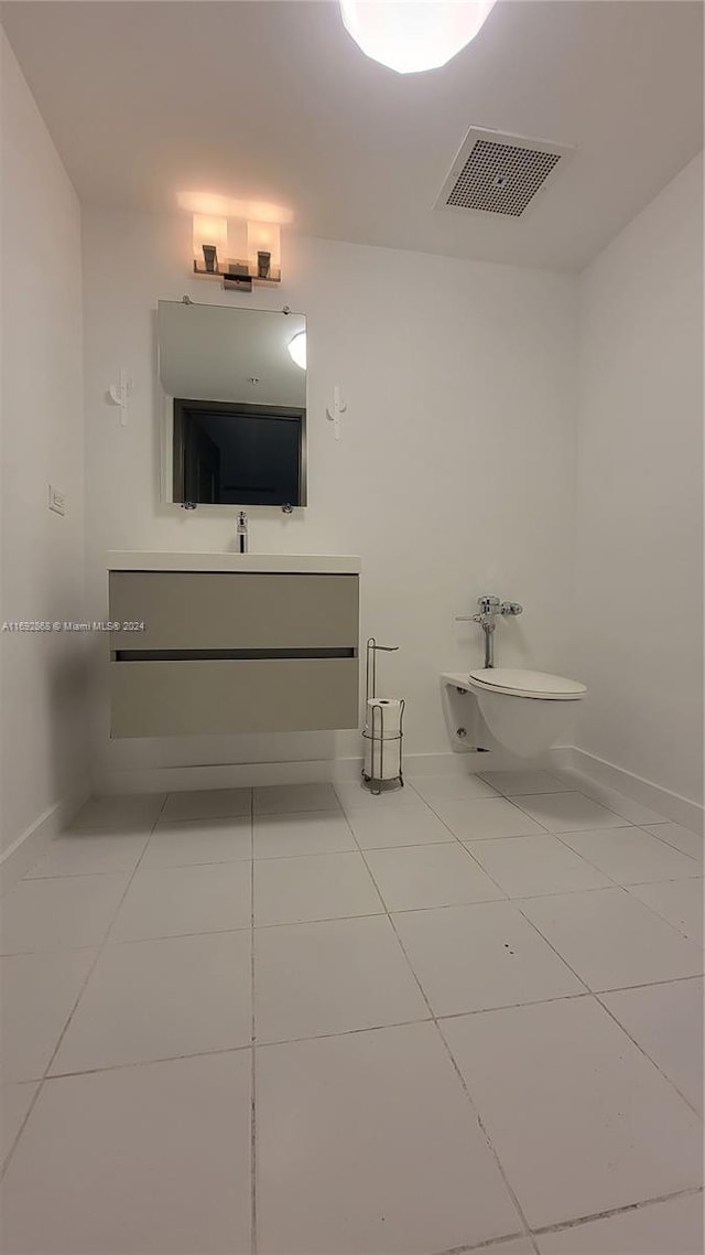 bathroom with tile patterned floors, vanity, and toilet