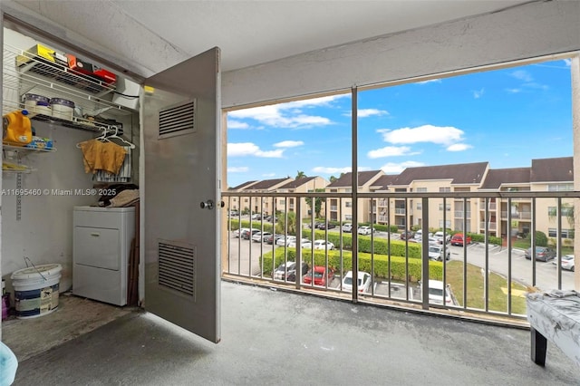 unfurnished sunroom featuring washer / clothes dryer