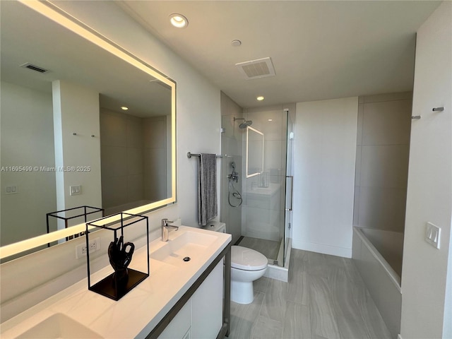 bathroom featuring toilet, vanity, and tiled shower