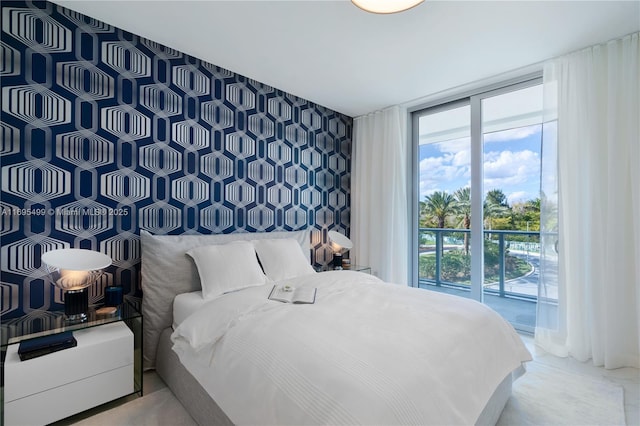 bedroom featuring a wall of windows and access to exterior