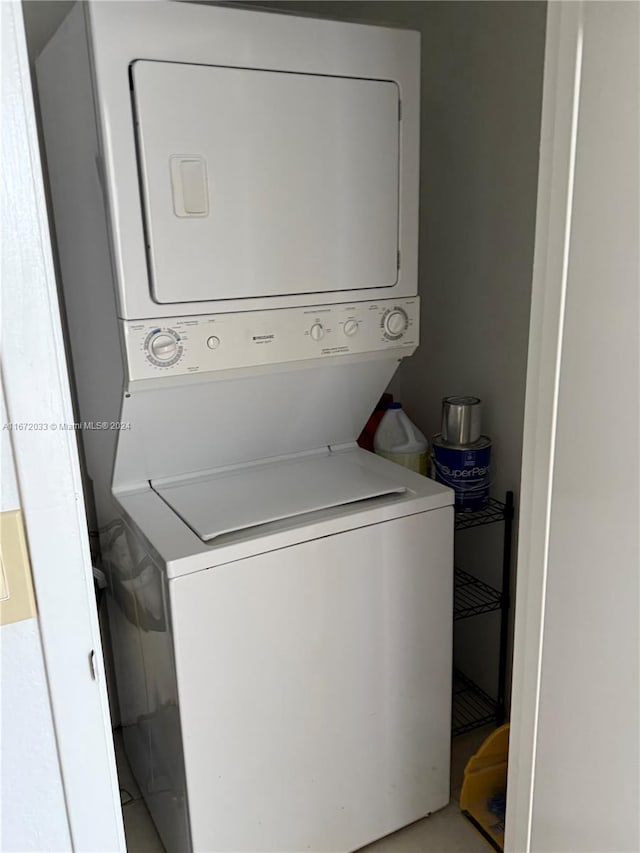 washroom featuring stacked washing maching and dryer