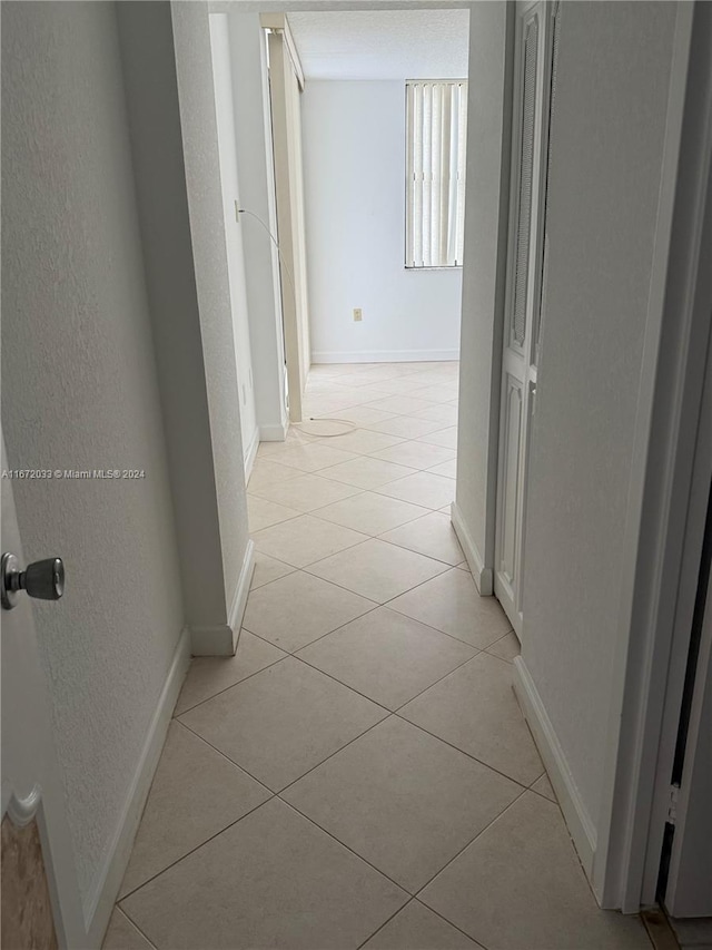 hallway with light tile patterned flooring