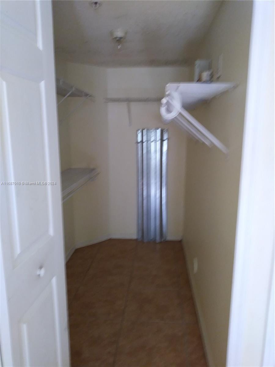 spacious closet with tile patterned flooring