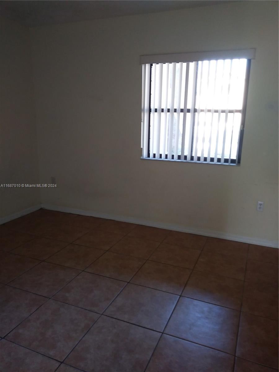 spare room with tile patterned floors