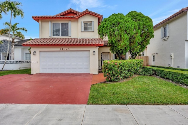 mediterranean / spanish-style house with a garage and a front lawn