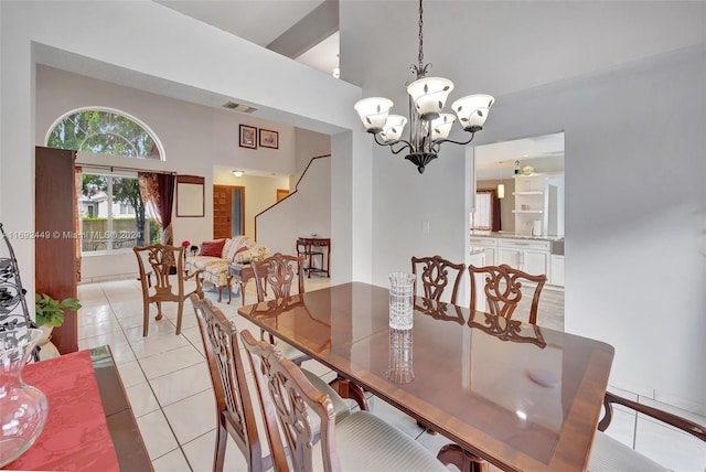 tiled dining room with a notable chandelier