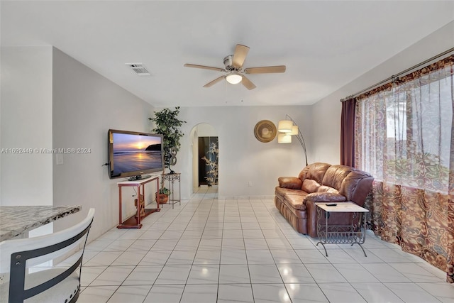 living room featuring light tile patterned floors and ceiling fan