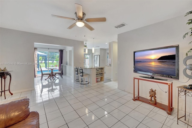 tiled living room featuring ceiling fan