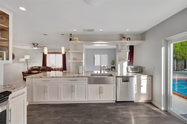 kitchen with dishwasher, white cabinets, sink, ceiling fan, and light stone countertops