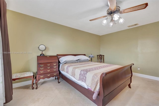 bedroom with ceiling fan and light tile patterned floors