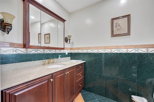 bathroom featuring tile patterned flooring, vanity, and tile walls