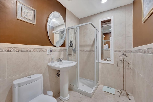 bathroom with an enclosed shower, tile walls, and toilet