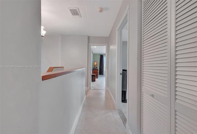 corridor with a textured ceiling