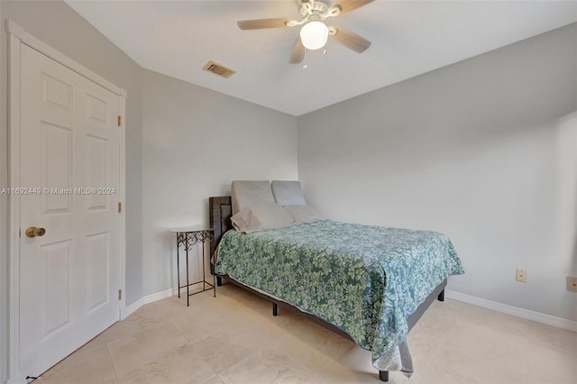 bedroom with tile patterned floors and ceiling fan