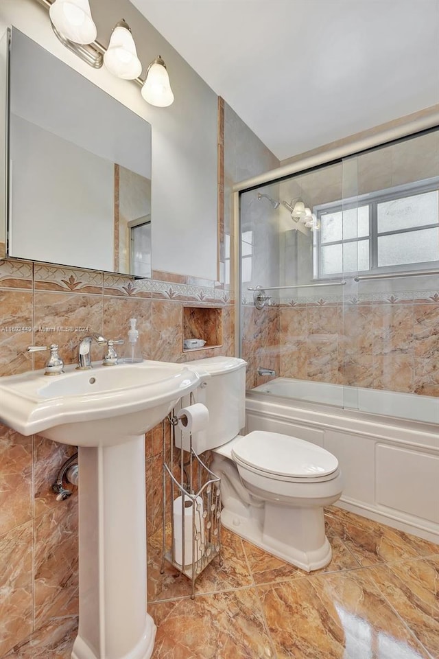 bathroom with toilet, enclosed tub / shower combo, tile walls, and tasteful backsplash