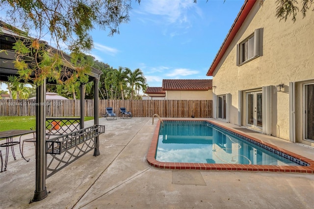 view of pool with french doors and a patio