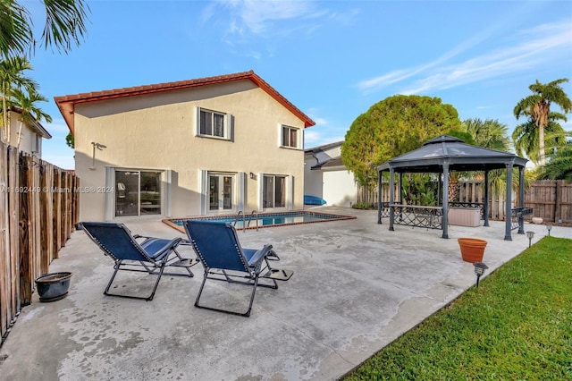 exterior space with a gazebo, a patio, and a fenced in pool