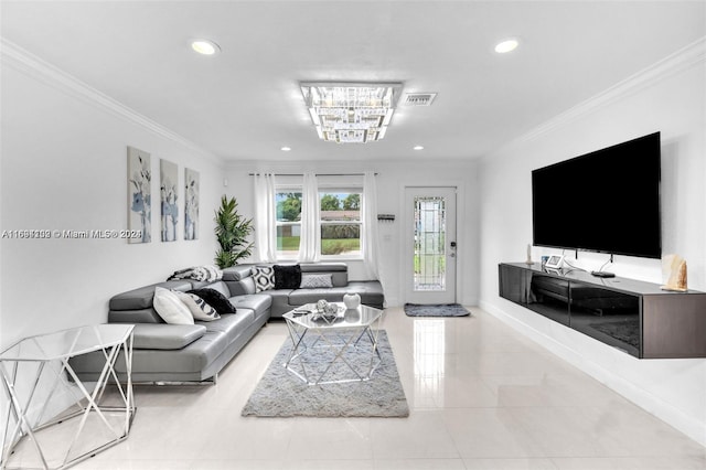 living room with ornamental molding and a chandelier