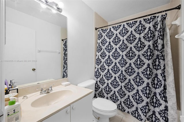 bathroom with tile patterned floors, vanity, toilet, and curtained shower