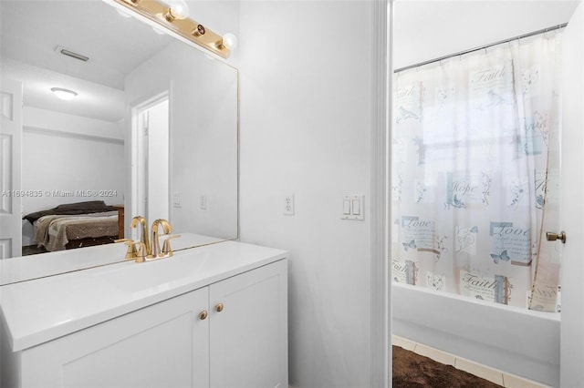 bathroom with tile patterned flooring, vanity, and shower / tub combo