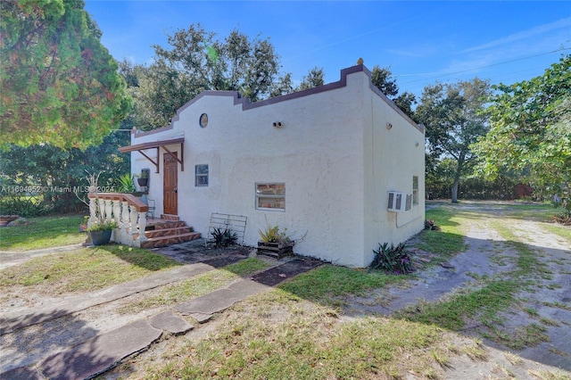 view of side of home featuring a lawn