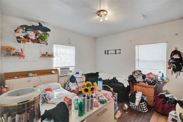 bedroom with hardwood / wood-style floors and cooling unit