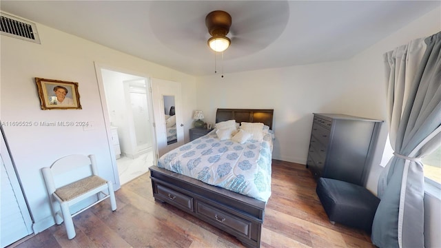 bedroom featuring connected bathroom, ceiling fan, and hardwood / wood-style flooring