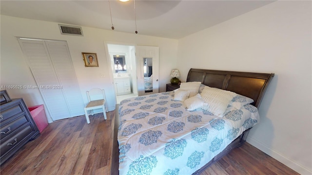 bedroom with dark hardwood / wood-style flooring, connected bathroom, and a closet