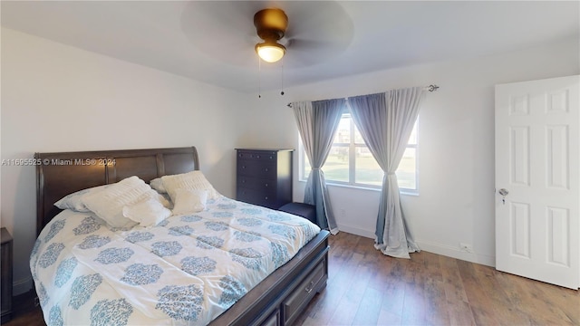 bedroom with hardwood / wood-style floors and ceiling fan