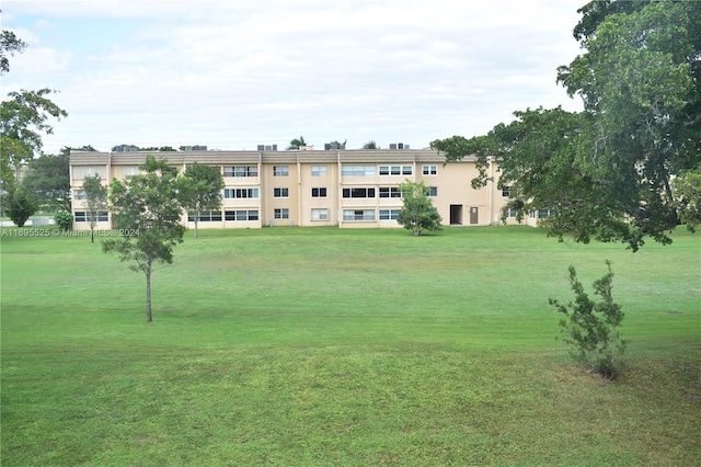 view of property's community with a yard