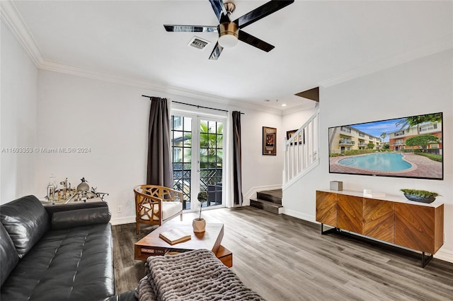 living room featuring ceiling fan, wood-type flooring, and ornamental molding