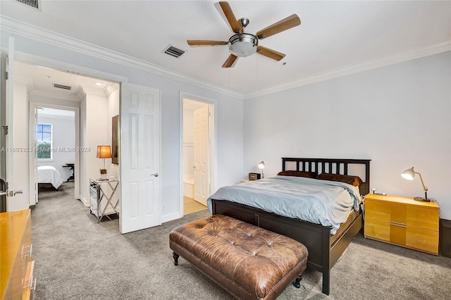 bedroom featuring ceiling fan, ensuite bathroom, carpet floors, and crown molding