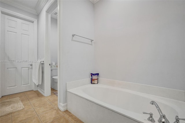 bathroom featuring tile patterned floors, toilet, a bathtub, and crown molding